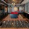 Large well lit game room with wood floors and a pool table