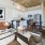 Spacious and well lit living room with wood floors and an open floor plan with access to the kitchen.