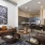Spacious and well lit living room with wood floors and an open floor plan with access to the kitchen.
