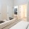 Spacious and well lit bedroom with plush carpet and large windows