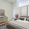 Spacious and well lit bedroom with plush carpet and large windows