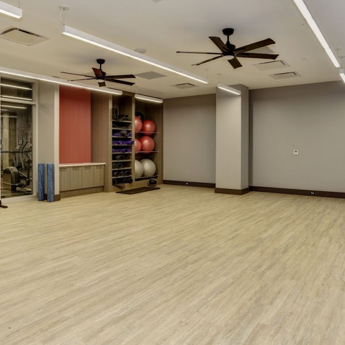 Large well light yoga room with wood floors 