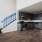 Spacious and well lit kitchen with wood floors and stainless steel appliances. 