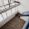 Spacious and well lit living room with wood floors and an open floor plan with access to the kitchen.