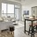 Spacious and well lit kitchen with wood floors and stainless steel appliances. 