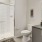 Large bathroom with white cabinets and granite counter tops.