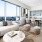 Spacious and well lit living room with wood floors and an open floor plan with access to the kitchen.