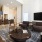 Spacious and well lit living room with wood floors and an open floor plan with access to the kitchen.