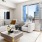 Spacious and well lit living room with wood floors and an open floor plan with access to the kitchen.
